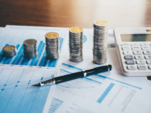 Revenue operations performance dashboard with growing coin stacks, financial charts, and calculator representing forecast accuracy and predictable pipeline growth